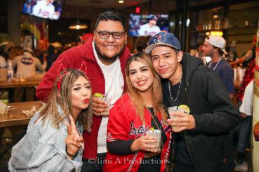 Friends Pose in Bar Rooting for Braves