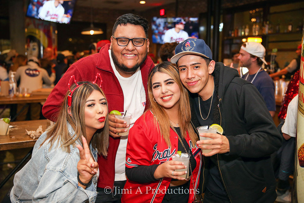 Friends Pose in Bar Rooting for Braves