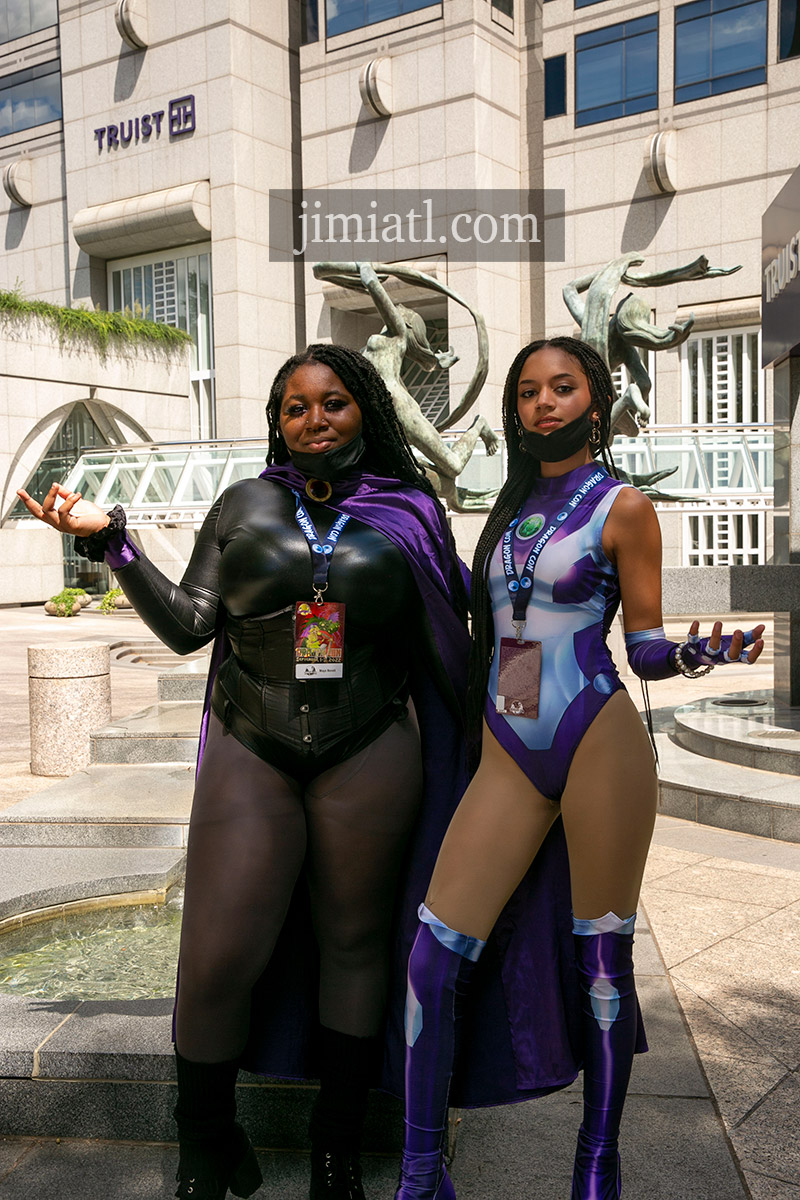 Women in Caped Purple Costumes